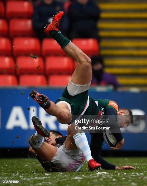 Tigers wing Jonny May is tackled in the air by Racing fullback Brice Dulin during the European Rugby Champions Cup match between Leicester Tigers and...