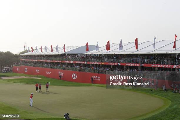 Tommy Fleetwood of England celebrates after putting for birdie on the 18th green to finish 22 under and win during the final round of the Abu Dhabi...