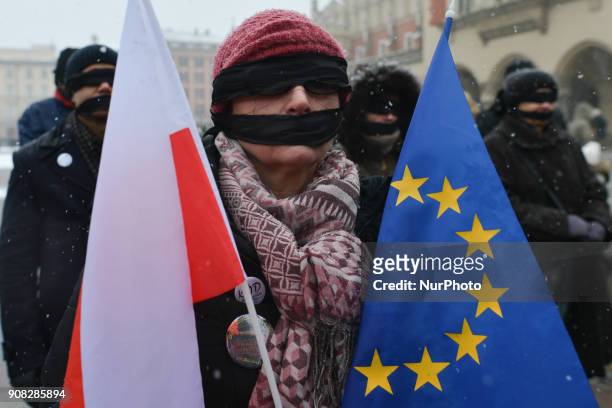Members of the Polish opposition and activists, wearing black bands in front of their eyes and mouth, aligned equally in rows silent for 20 minutes...