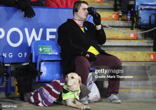 An image impaired football fan with his seeing dog during the Premier League match between Leicester City and Watford at The King Power Stadium on...