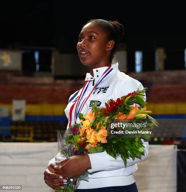 Coraline Vitalis of France watches the French flag raise after winning the gold medal match at the Women's Epee World Cup on January 20, 2018 at the...