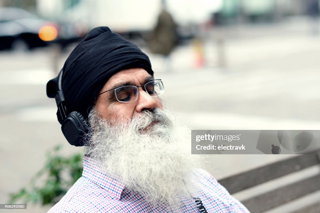 Older man listening to music