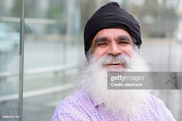 portrait of smiling sikh man - turban stock pictures, royalty-free photos & images