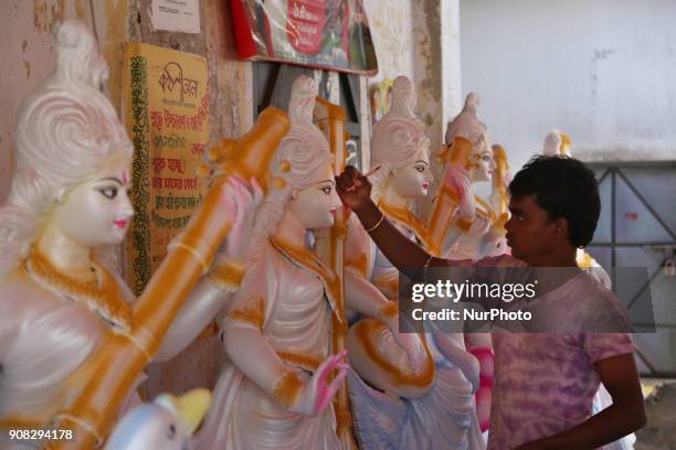 An artist giving his final touch to an idol of Devi Saraswati at Jagannath Hall of Dhaka University, Bangladesh, on 21 January 2018.