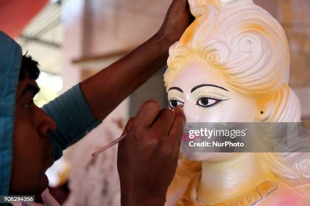 An artist giving his final touch to an idol of Devi Saraswati at Jagannath Hall of Dhaka University, Bangladesh, on 21 January 2018.