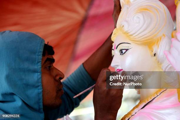 An artist giving his final touch to an idol of Devi Saraswati at Jagannath Hall of Dhaka University, Bangladesh, on 21 January 2018.