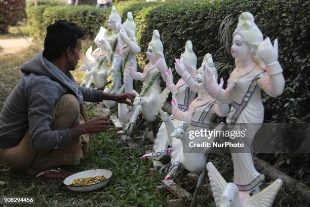 An artist giving his final touch to an idol of Devi Saraswati at Jagannath Hall of Dhaka University, Bangladesh, on 21 January 2018.