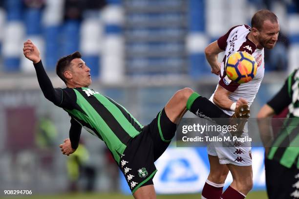 Federico Peluso of Sassuolo and Lorenzo De Silvestri of Torino compete for the ball during the serie A match between US Sassuolo and Torino FC at...