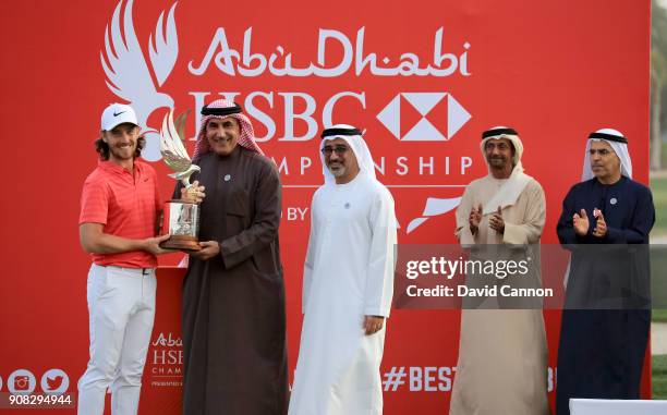 Tommy Fleetwood of England is presented with the Falcon Trophy by Major General Khalfan Al Romaithi The Chairman of the UAE General Authority of...