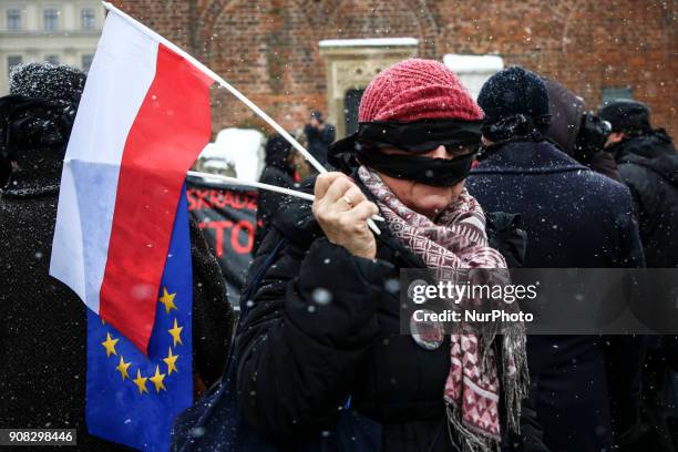 People wearing black bands on their eyes and mouth demonstrate in Stolen Justice silent protest at the Main Square in Krakow, Poland on 21 January,...