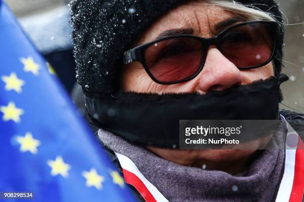 People wearing black bands on their eyes and mouth demonstrate in Stolen Justice silent protest at the Main Square in Krakow, Poland on 21 January,...