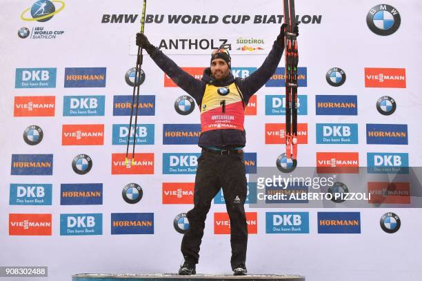 Winner France's Martin Fourcade celebrates on the podium of the Men 15 km Mass Start Competition of the IBU World Cup Biathlon in Anterselva on...
