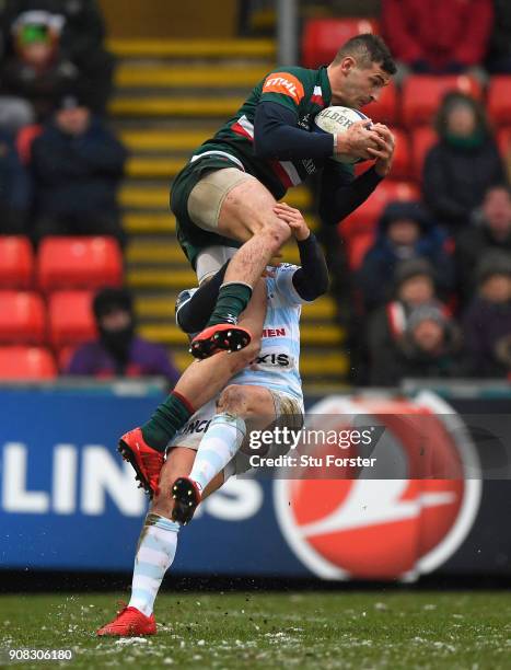 Tigers wing Jonny May is tackled in the air by Racing fullback Brice Dulin during the European Rugby Champions Cup match between Leicester Tigers and...