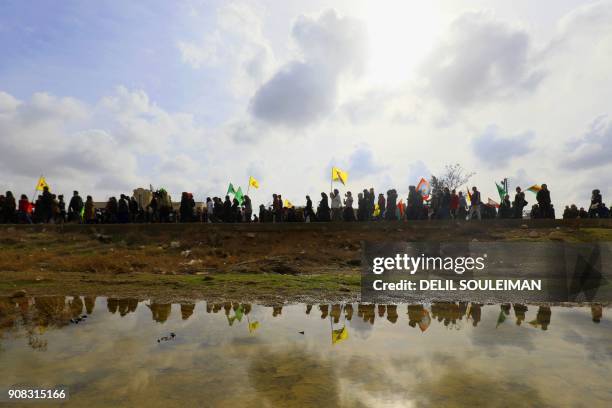 Syrian-Kurds take part in a demonstration in the town of Amuda, some 30 kilometres west of Qamishli, a Kurdish-majority city in northeastern Hasakeh...