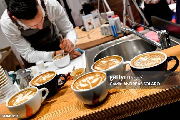 Barman decorates cappuccino during the 39th Gelato , Pastry, Bakery and Coffe International World fair in Rimini, on January 21, 2018. / AFP PHOTO /...
