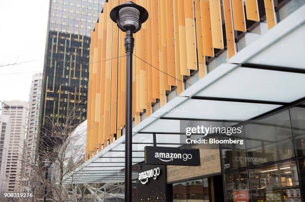 Signage is displayed outside the Amazon Go store in Seattle, Washington, U.S., on Wednesday, Jan. 17, 2018. After more than a year of testing with an...