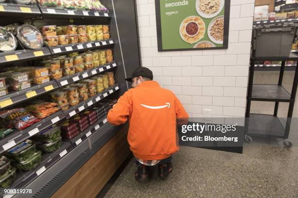 An employee stocks shelves at the Amazon Go store in Seattle, Washington, U.S., on Wednesday, Jan. 17, 2018. After more than a year of testing with...