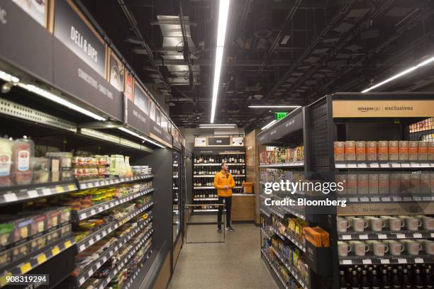 An employee stands at the Amazon Go store in Seattle, Washington, U.S., on Wednesday, Jan. 17, 2018. After more than a year of testing with an...