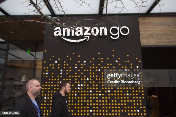 Pedestrians walk past the Amazon Go store in Seattle, Washington, U.S., on Wednesday, Jan. 17, 2018. After more than a year of testing with an...