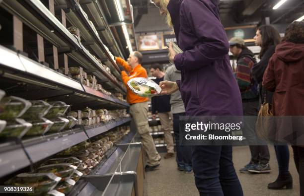 An Amazon.com Inc. Employee shops for salad at the Amazon Go store in Seattle, Washington, U.S., on Wednesday, Jan. 17, 2018. After more than a year...