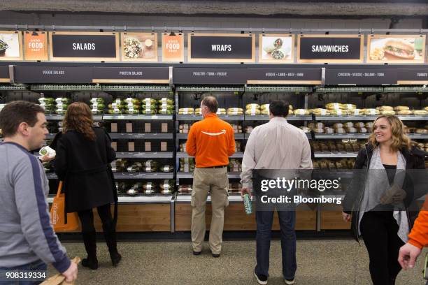 Amazon.com Inc. Employees shop at the Amazon Go store in Seattle, Washington, U.S., on Wednesday, Jan. 17, 2018. After more than a year of testing...
