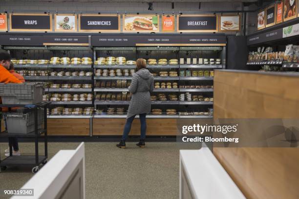 An Amazon.com Inc. Employee shops for prepared food at the Amazon Go store in Seattle, Washington, U.S., on Wednesday, Jan. 17, 2018. After more than...
