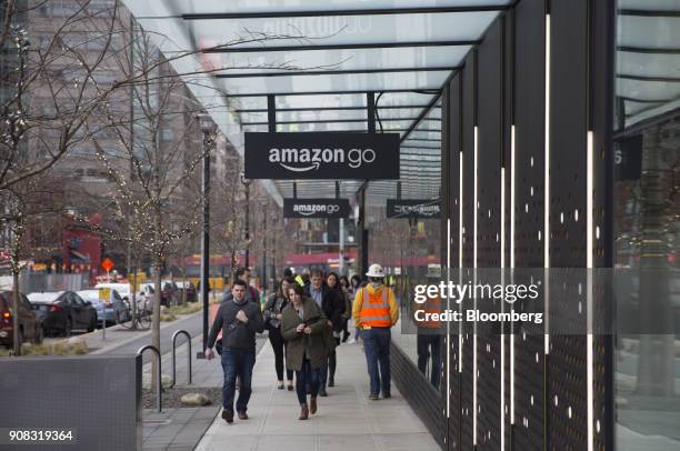 Pedestrians walk past the Amazon Go store in Seattle, Washington, U.S., on Wednesday, Jan. 17, 2018. After more than a year of testing with an...