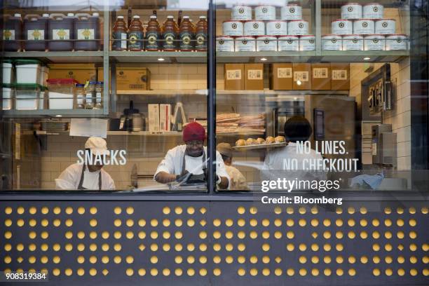 Employees prepare fresh food items at the Amazon Go store in Seattle, Washington, U.S., on Wednesday, Jan. 17, 2018. After more than a year of...