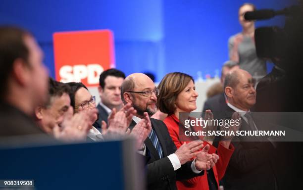 Martin Schulz , leader of Germany's social democratic SPD party, and leadership members applaud after delegates voted to begin formal coalition talks...
