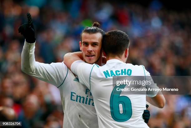 Gareth Bale of Real Madrid CF celebrates scoring their second goal with teammate Nacho Fernandez during the La Liga match between Real Madrid CF and...