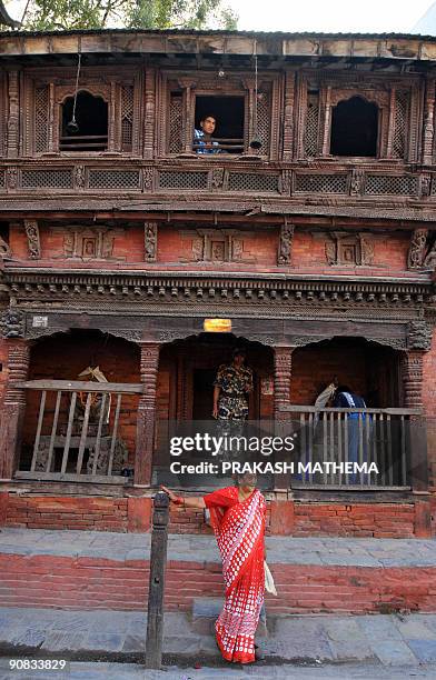 Nepalese man looks on from a window during the first day of Indra Jatra festival in Hanuman Dhoka, Kathmandu on September 1, 2009. The eight-day long...