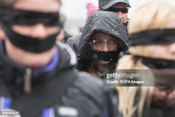 People use black bands over their eyes and mouths during a silent assembly named Stolen Justice in Krakow. Stolen Justice happening, intend to...