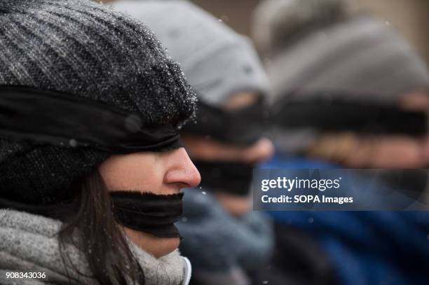 Woman uses black bands over her eyes and mouth during a silent assembly named Stolen Justice in Krakow. Stolen Justice happening, intend to express...