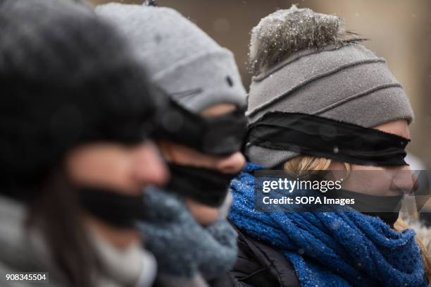 Woman uses black bands over her eyes and mouth during a silent assembly named Stolen Justice in Krakow. Stolen Justice happening, intend to express...