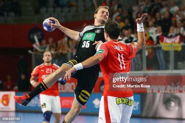 Julius Kuehn of Germany is challenged by Rasmus Lauge Schmidt of Denmark during the Men's Handball European Championship main round group 2 match...