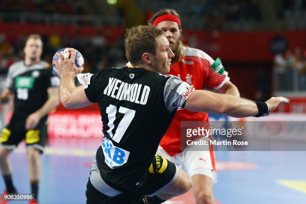 Steffen Weinhold of Germany eludes Mikkel Hansen of Denmark during the Men's Handball European Championship main round group 2 match between Germany...