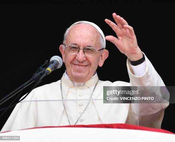 Pope Francis waves to the crowd gathered at Plaza de Armas square in Lima from the balcony of the Archiepiscopal Palace, at the end of his Angelus...