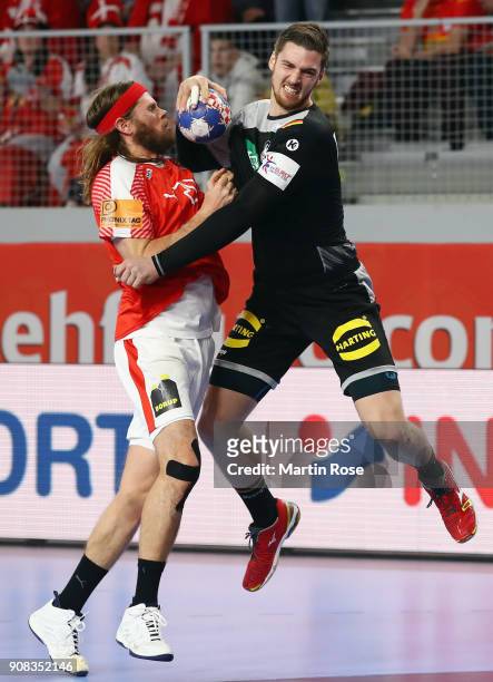Hendrik Pekeler of Germany is challenged by Mikkel Hansen of Denmark during the Men's Handball European Championship main round group 2 match between...