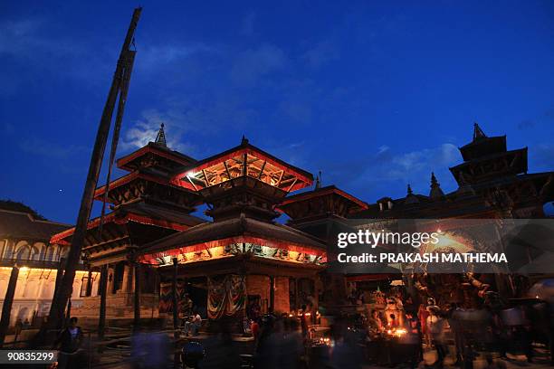 Nepalese Hindus walk past the Hanuman Dhoka on the first day of the Hindu festival Indra Jatra in Kathmandu on September 1, 2009. The eight-day long...