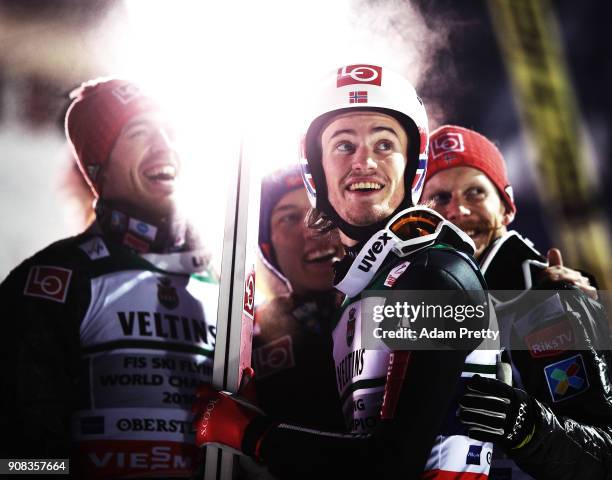 Daniel Andre Tande of Norway celebrates with team mates Robert Johansson, Andreas Stjernen and Johann Andre Forfang of Norway after winning the gold...