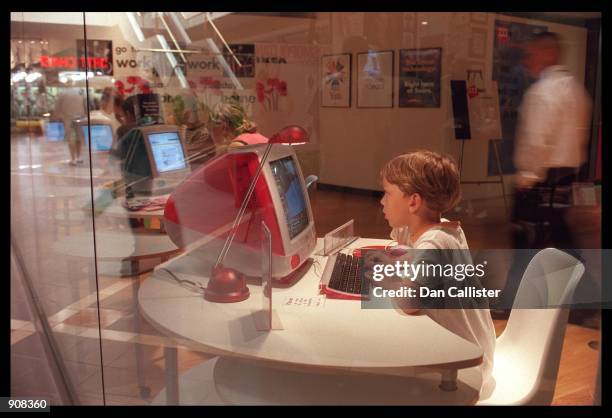 Burbank, CA. A young boy uses a computer to hook upto the net at the Cyber cafe in the Innovations 99 convention at the Media Shopping centre in...