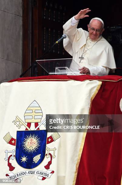 Pope Francis waves to the crowd gathered at Plaza de Armas square in Lima from the balcony of the Archiepiscopal Palace, at the end of his Angelus...