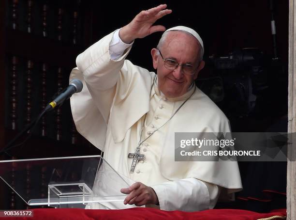 Pope Francis waves to the crowd gathered at Plaza de Armas square in Lima from the balcony of the Archiepiscopal Palace, at the end of his Angelus...