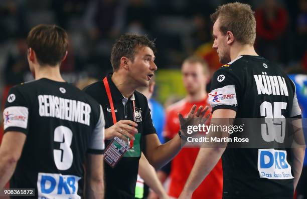 Head coach Christian Prokop of Germany talks to Julius Kuehn during the Men's Handball European Championship main round group 2 match between Germany...