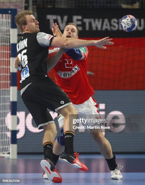 Julius Kuehn of Germany is challenged by Henrik Toft Hansen of Denmark during the Men's Handball European Championship main round group 2 match...