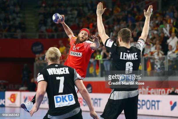 Mikkel Hansen of Denmark is challenged by Finn Lemke and Patrick Wiencek of Germany during the Men's Handball European Championship main round group...