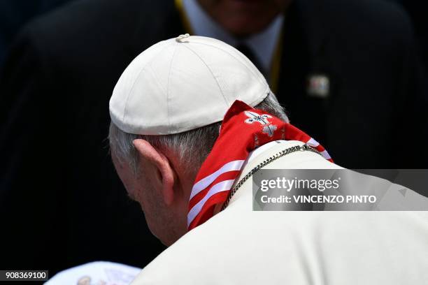 Pope Francis wears a scarf, adorned with a fleur de lys and the Peruvian national colours, given by a boy after delivering his Angelus prayer in Lima...