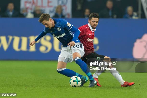 Bastian Oczipka of Schalke and Julian Korb of Hannover battle for the ball during the Bundesliga match between FC Schalke 04 and Hannover 96 at...
