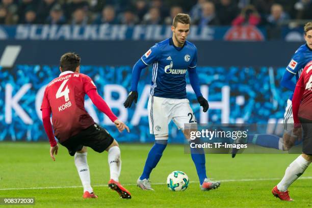 Julian Korb of Hannover and Marko Pjaca of Schalke battle for the ball during the Bundesliga match between FC Schalke 04 and Hannover 96 at...