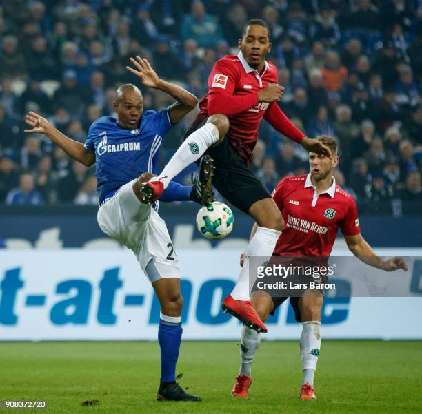 Naldo of Schalke is challenged by Charlison Benshop of Hannover during the Bundesliga match between FC Schalke 04 and Hannover 96 at Veltins-Arena on...